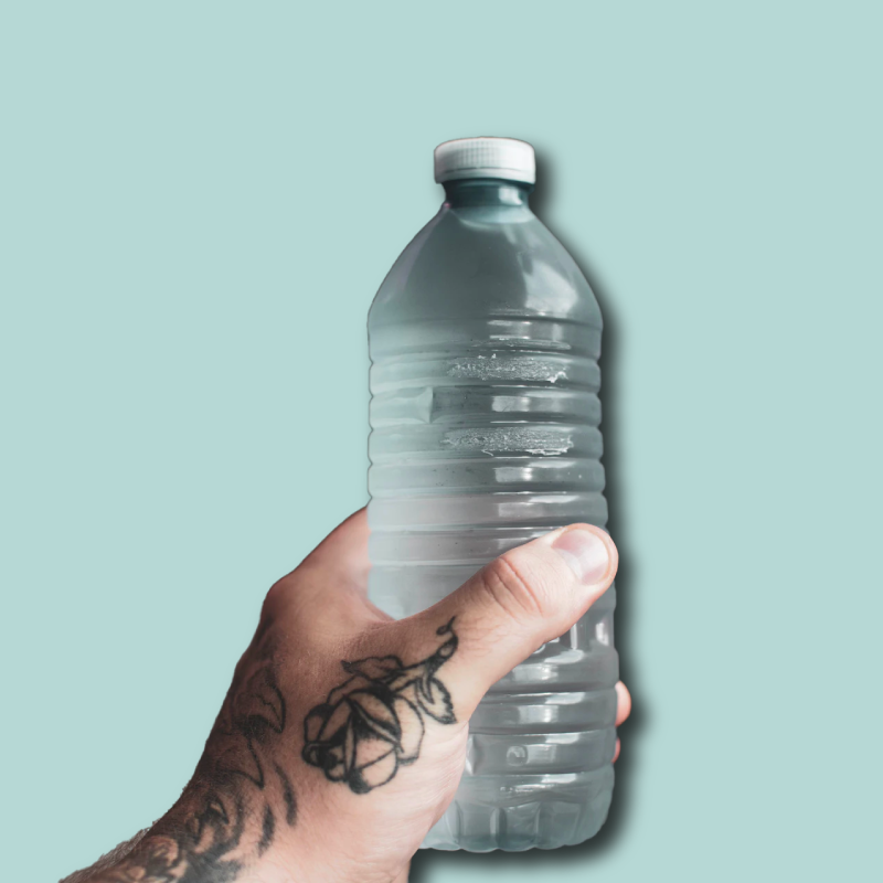 tattooed hand holding plastic bottled water