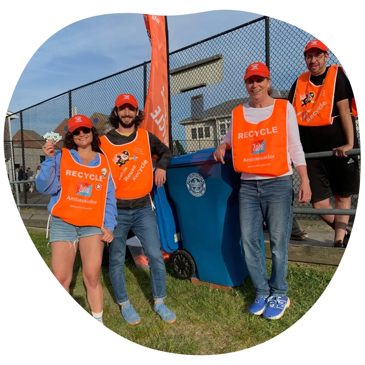 people standing by recycling bin