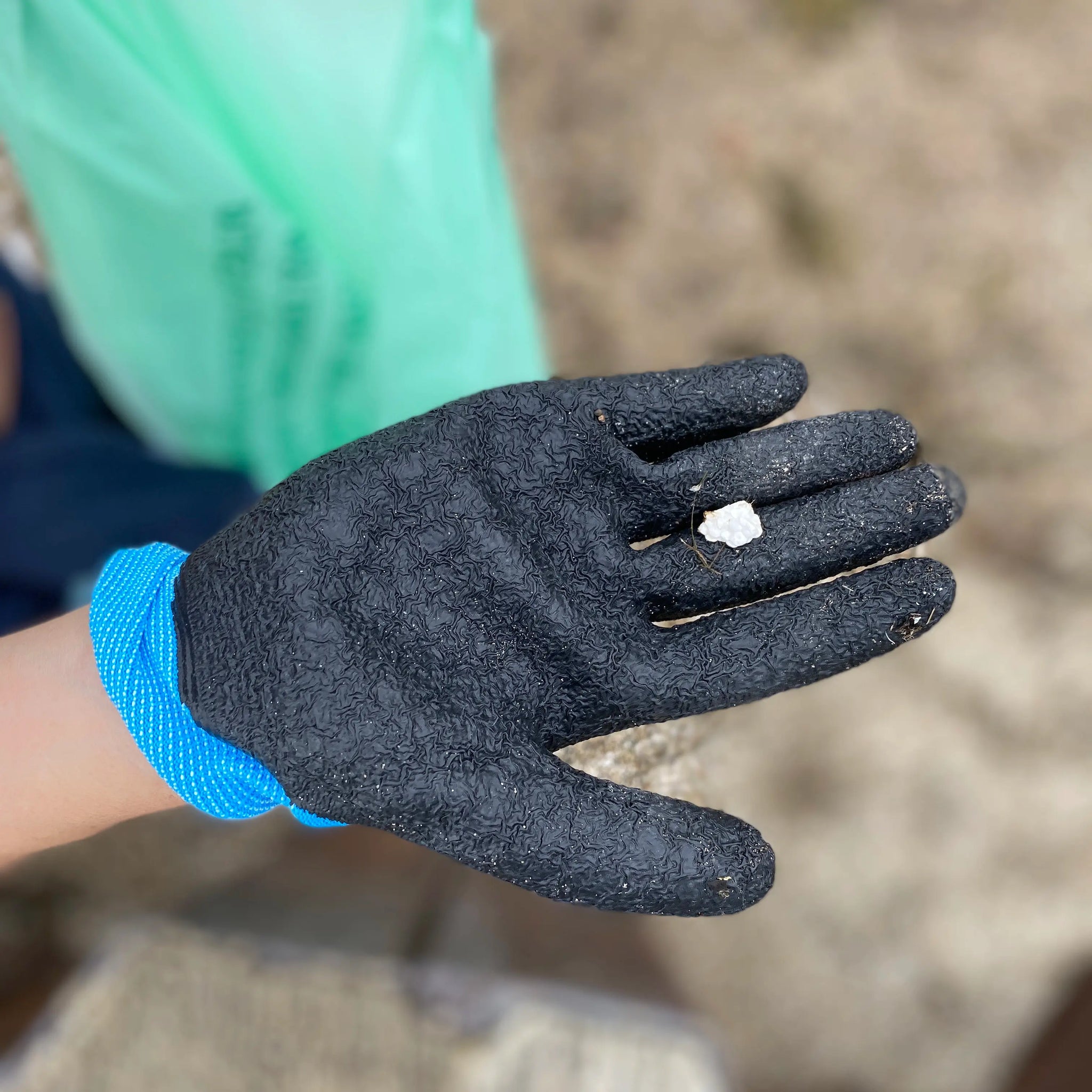 gloved hand with styrofoam piece