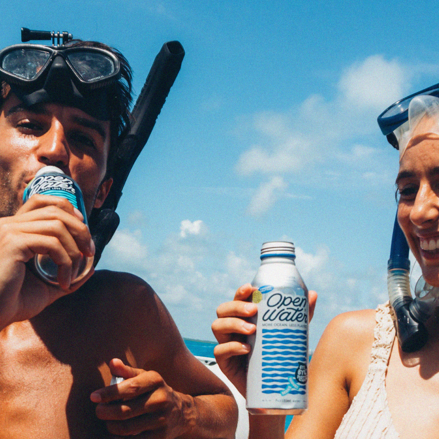 People drinking Open Water canned water in aluminum by the ocean